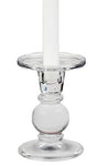 A glass dual-size candle holder (5") beautifully showcases a white taper candle, emitting a warm glow.