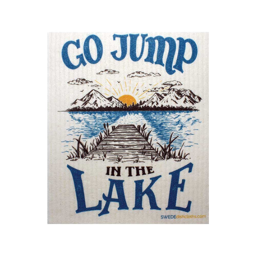 A depiction of a wooden dock extending into a lake, framed by mountains and a serene sunrise, encapsulates the tranquil beauty of nature. The text reads "Go Jump in the Lake." This Swedish dish cloth is crafted using sustainable raw materials, serving as a reminder to cherish and preserve our planet's natural wonders.