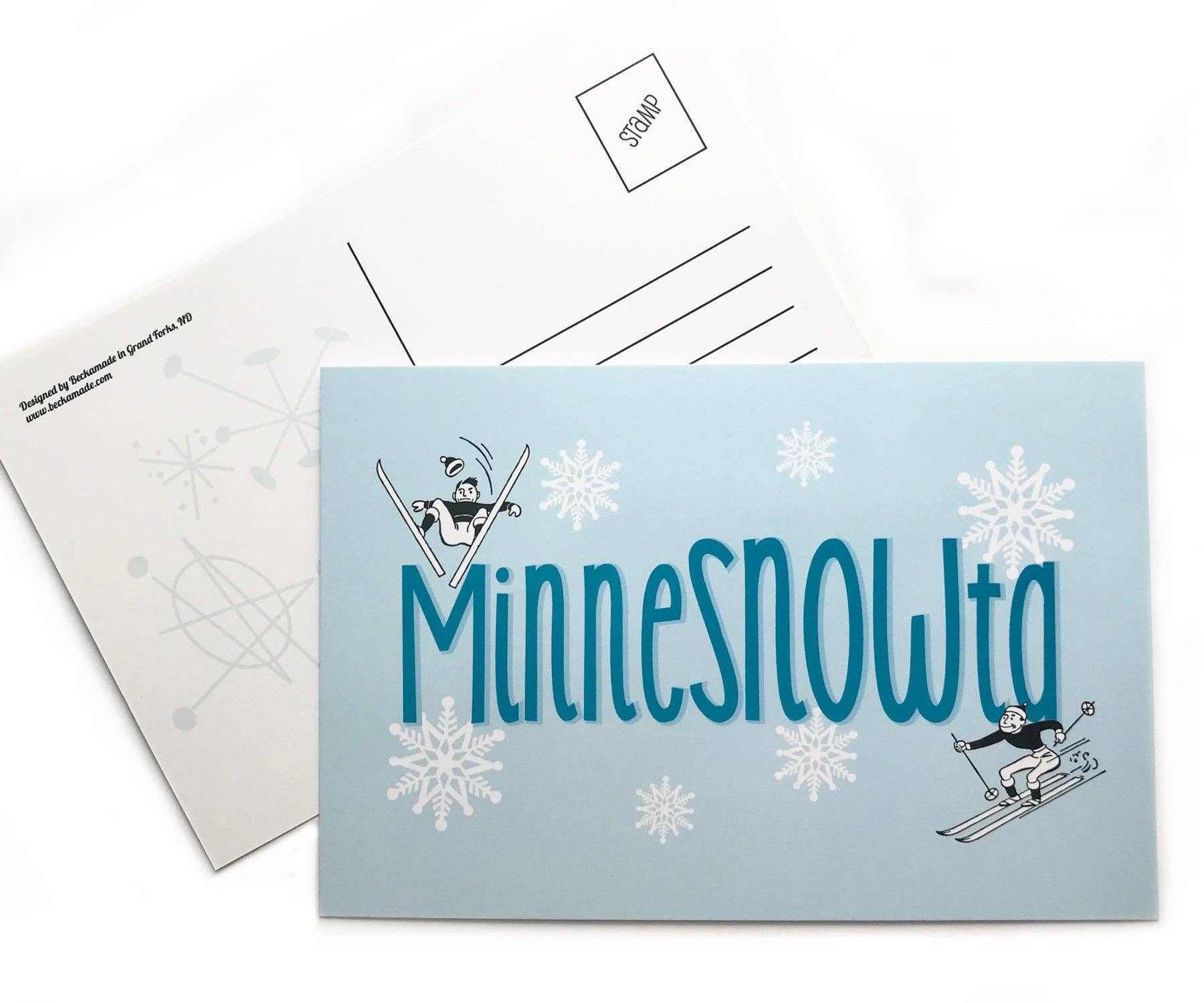 The front and back of the MinneSNOWta Postcard are designed on sturdy cardstock, showcasing whimsical cartoon skiers set against a blue snowy background with the text "MinneSNOWta.