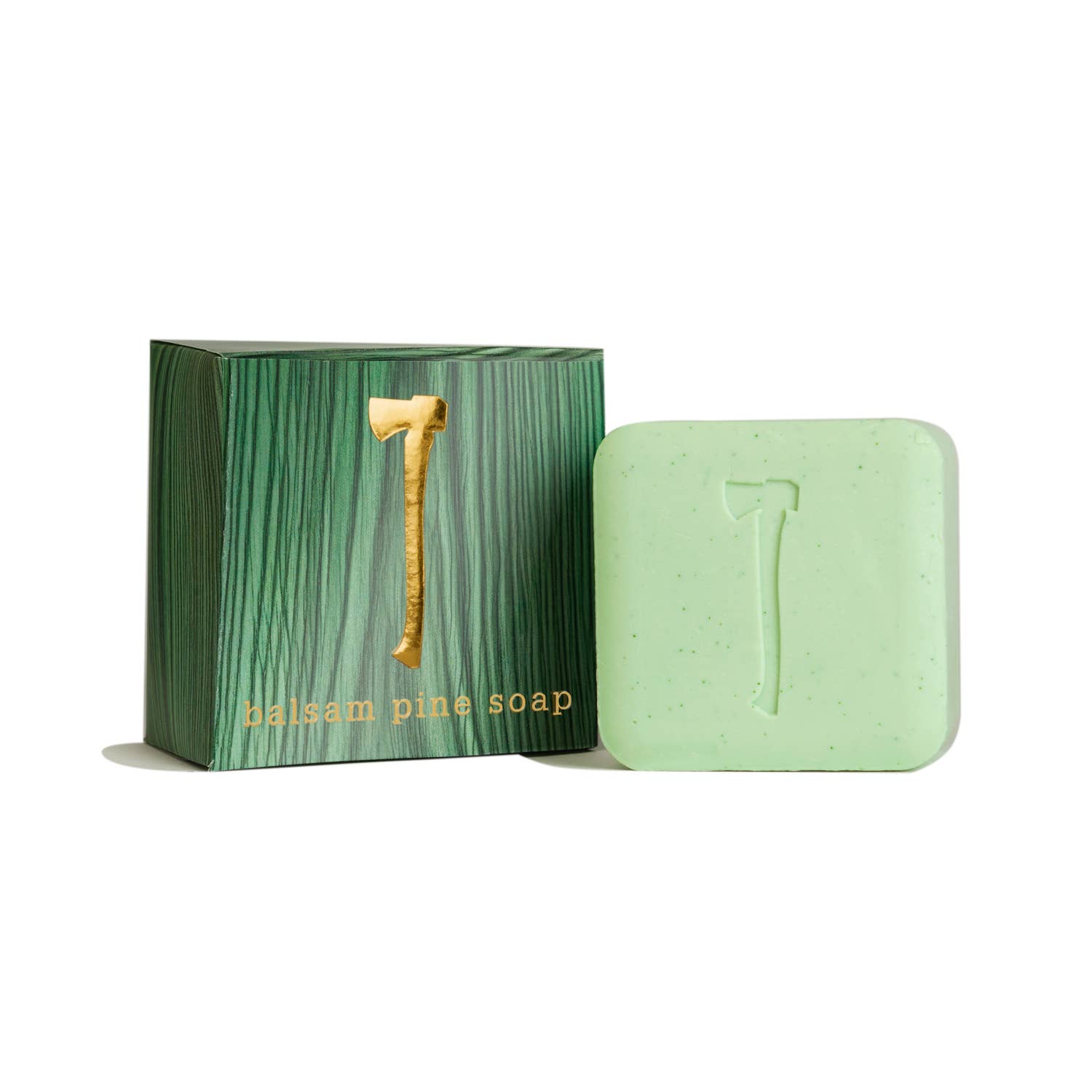The Balsam Pine Soap, designed with an axe motif, is paired with a complementary green textured box featuring a gold axe detail. Enriched with the essence of winter pine and natural exfoliators, this soap is ideal for revitalizing your skin during the colder months.