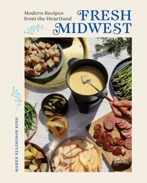 The cover of the book "Fresh Midwest" features a fondue pot accompanied by an array of bread, pickles, asparagus, meats, and sliced apples in a delightful table setting that celebrates traditional recipes made with local ingredients.