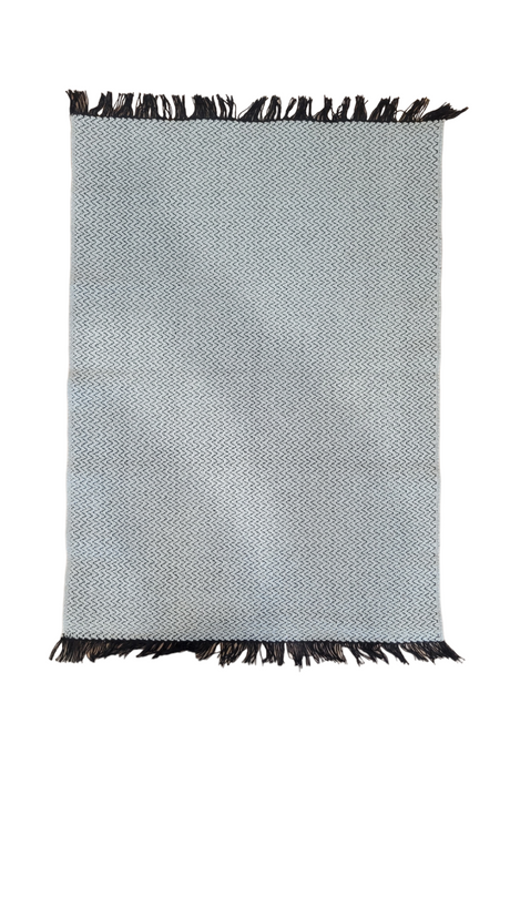 The Horredsmattan - Candy - Gray Vinyl Rug is a square, light gray woven accent with a subtle pattern and black fringe on all four sides, shown on a white background. It’s machine washable and stylish for any space.