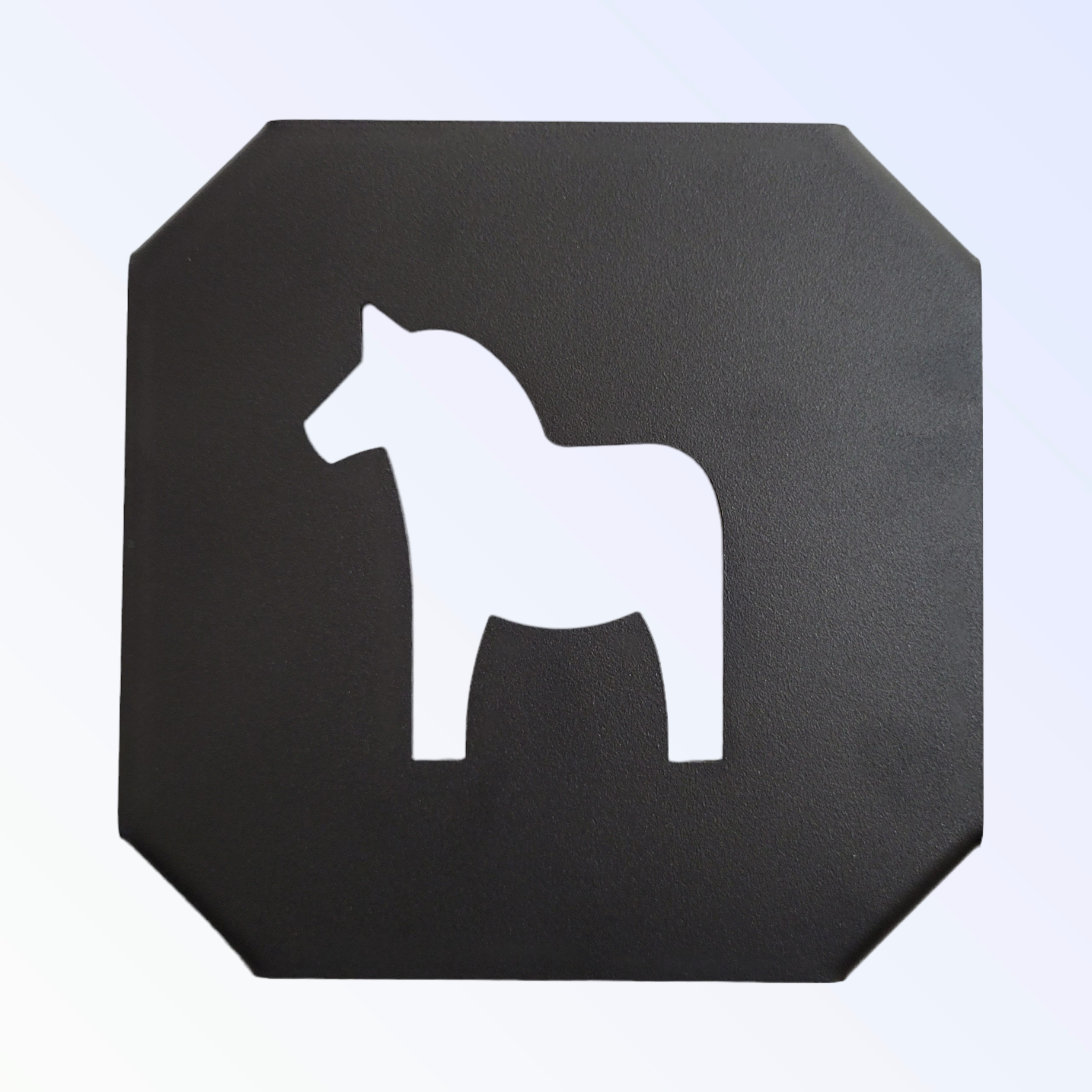 A black square sign with rounded corners showcases a white silhouette of a Swedish Dala horse, similar to the Trivet: Black w/ Dala Horse.