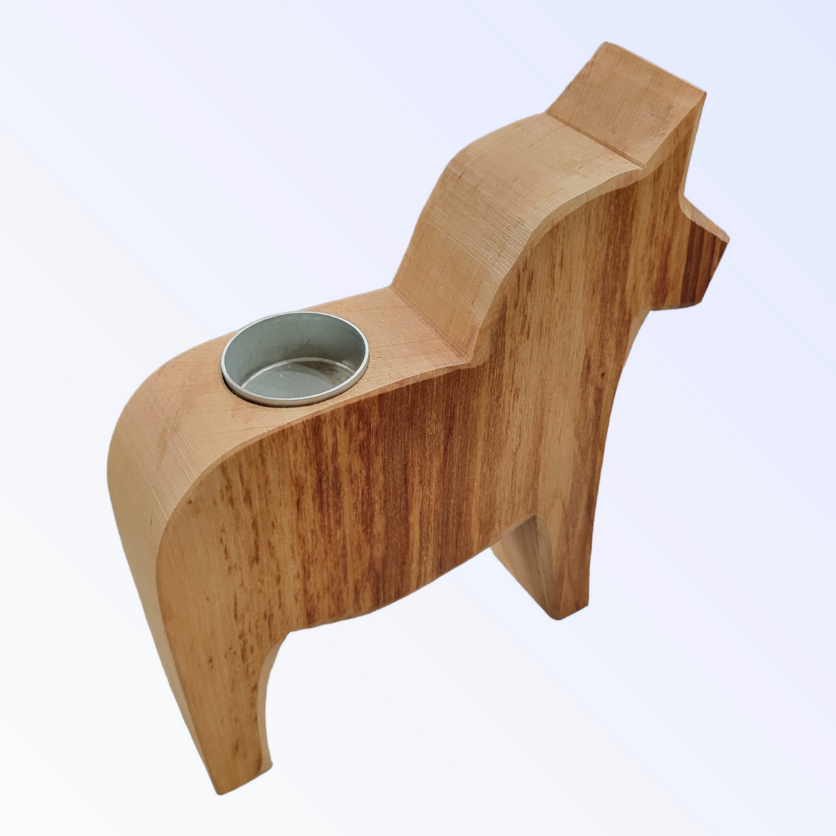 This 8" tall Candle Holder is a handcrafted Dala Horse tea light holder made of natural pine, featuring a horse shape with a round metal insert on its back for your favorite tea light.