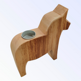 This 8" tall Candle Holder is a handcrafted Dala Horse tea light holder made of natural pine, featuring a horse shape with a round metal insert on its back for your favorite tea light.
