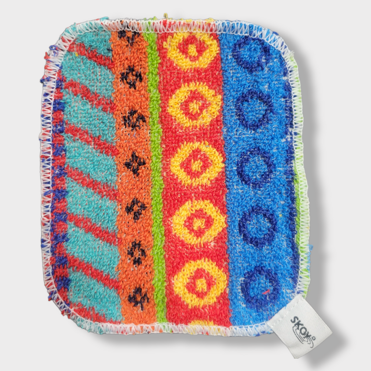 The Skoy Enterprises Dish Scrub: Skoy Scrub Cloths Good Clean Fun! is a vibrant, eco-friendly reusable kitchen scrubber with patterned stripes, stitched white edges, and a SKOY tag—perfect for stylish and sustainable cleaning.
