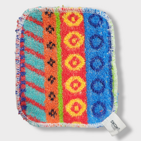 The Skoy Enterprises Dish Scrub: Skoy Scrub Cloths Good Clean Fun! is a vibrant, eco-friendly reusable kitchen scrubber with patterned stripes, stitched white edges, and a SKOY tag—perfect for stylish and sustainable cleaning.