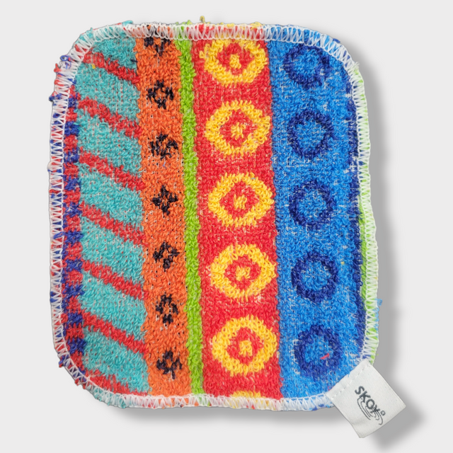 The Skoy Enterprises Dish Scrub: Skoy Scrub Cloths Good Clean Fun! is a vibrant, eco-friendly reusable kitchen scrubber with patterned stripes, stitched white edges, and a SKOY tag—perfect for stylish and sustainable cleaning.