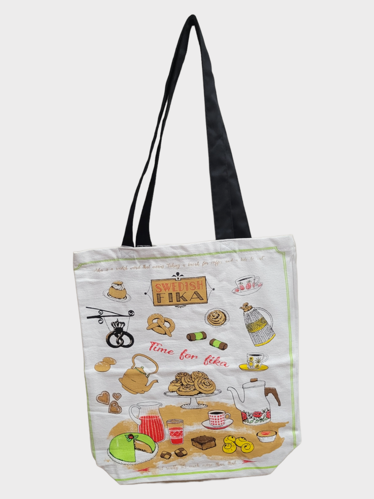 Introducing the Tote: Fika Shopping Tote, a textile bag adorned with whimsical cartoon designs of Swedish fika essentials such as coffee pots, pastries, and cups. The tote features the phrases "Swedish Fika" and "Time for Fika," set against a white background and complemented by black handles.