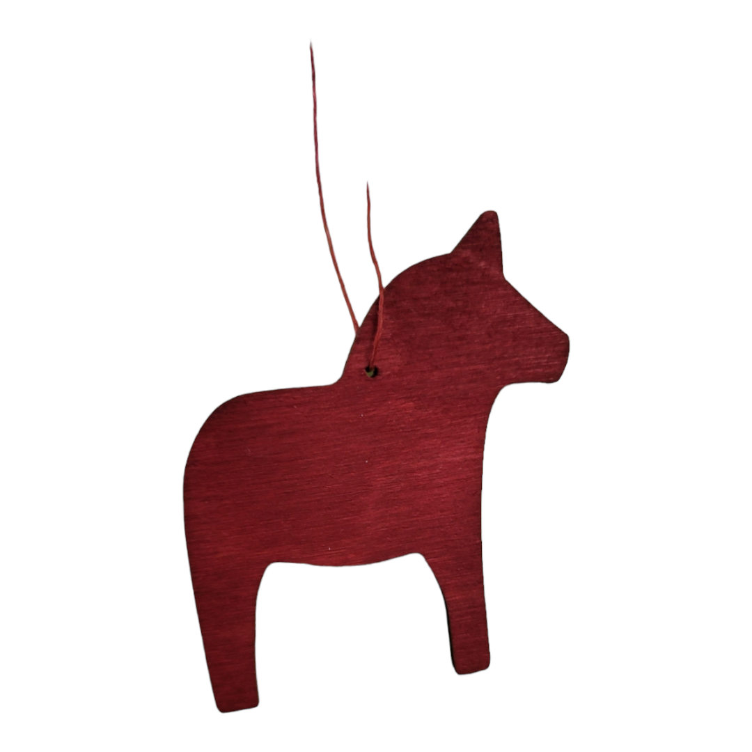 A dark red, flat wooden horse ornament with a small hole near the neck and a thin hanging string attached.