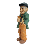This 8 1/2-inch figurine, titled "Man w/Pipe" by Bill Erickson, portrays an elderly man in a cap and green jacket, thoughtfully holding a pipe.