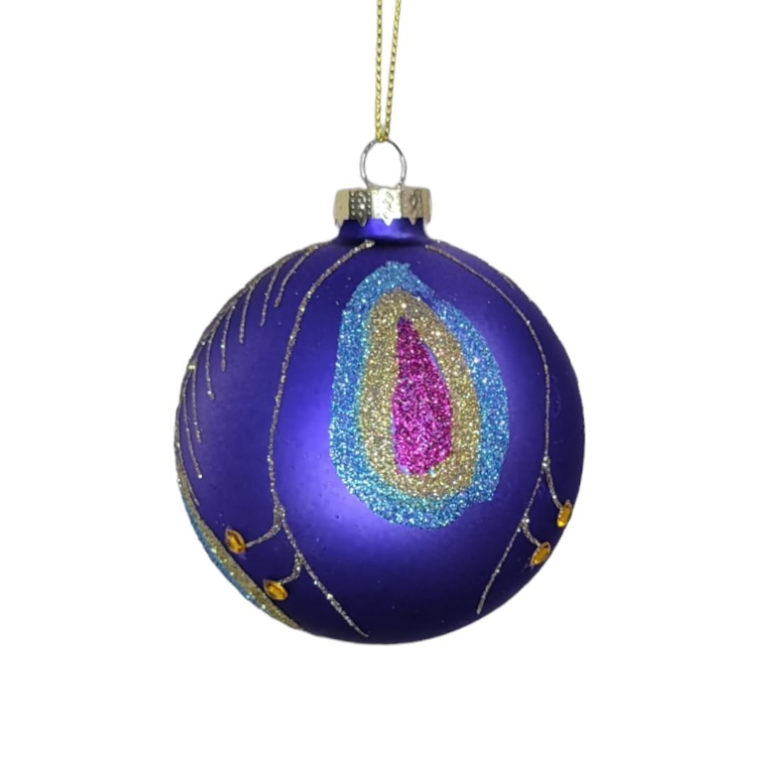 The Ornament: Peacock Glass Ball, a gem of holiday décor, boasts a high-quality design with its purple glass surface embellished with glittery pink, blue, and gold patterns that resemble peacock feathers. It is elegantly suspended by a golden string.