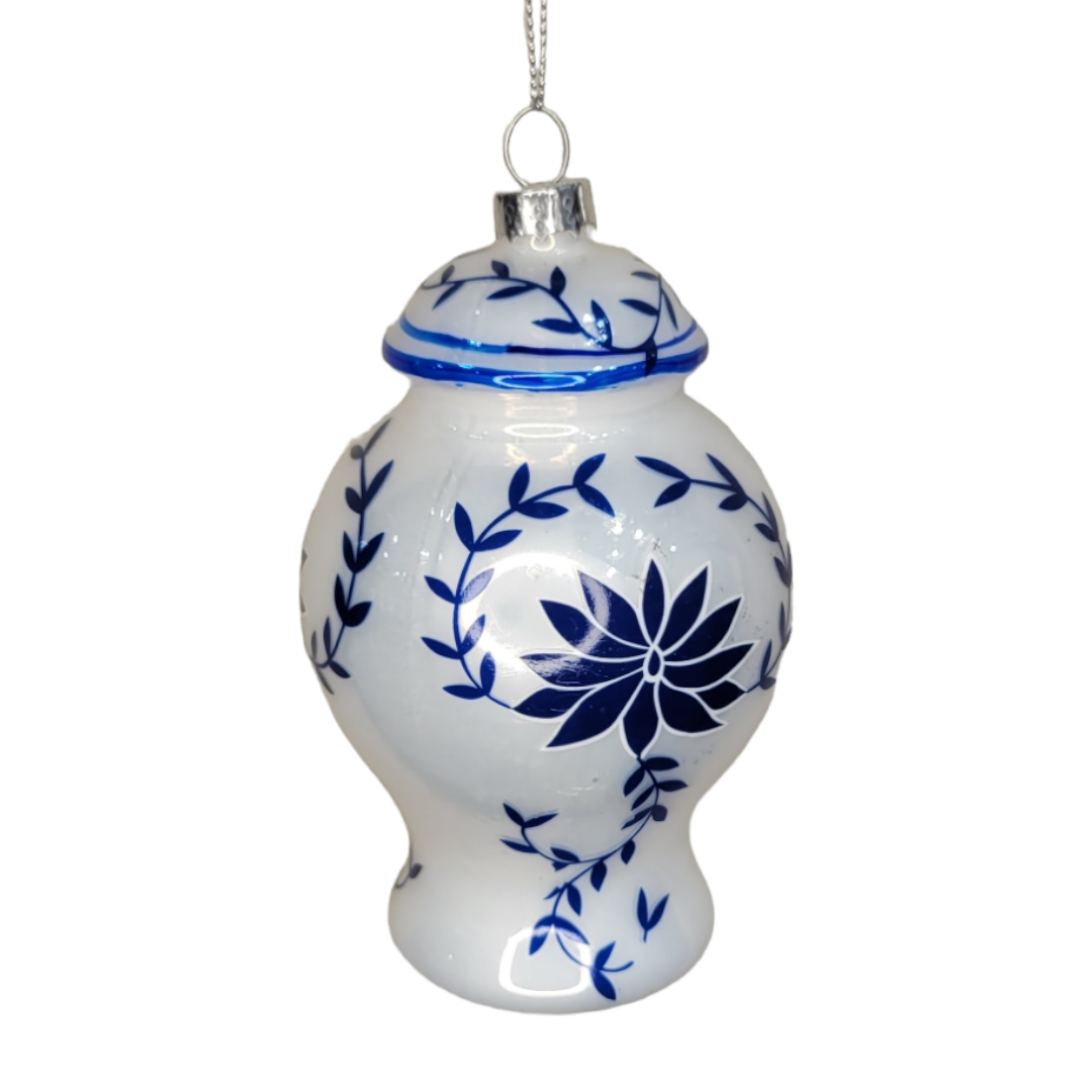 This Ornament: Teapot/Jar, made from white porcelain with blue floral designs, displays timeless elegance and exquisite craftsmanship as it hangs by a silver string.