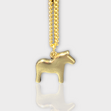 The Dala Horse Necklace by Anna Viktoria, featuring a gold horse-shaped pendant on a fine chain, embodies the elegance of Scandinavian jewelry and highlights the traditional Swedish symbol against a plain background.