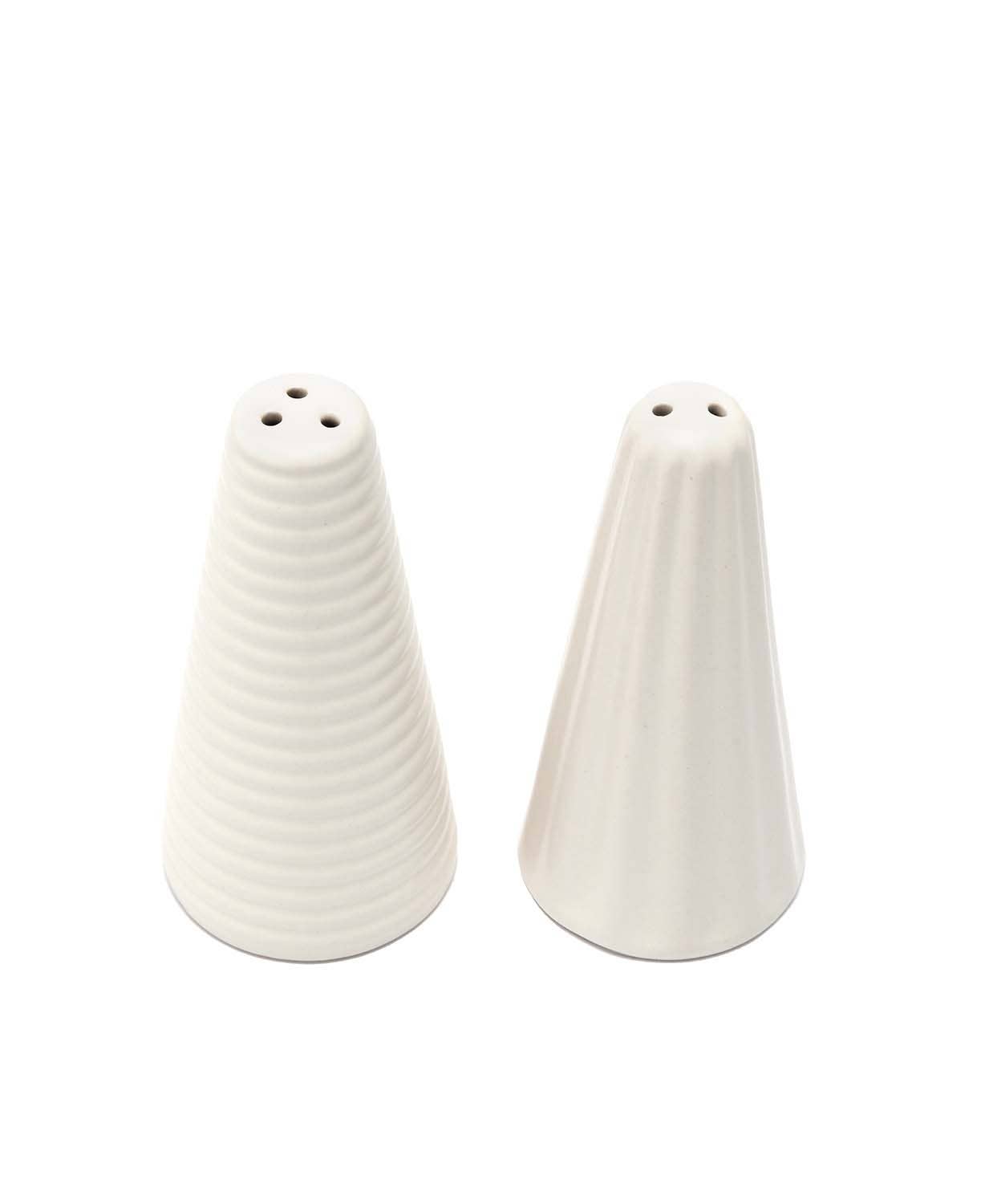 A pair of white ceramic Scandinavian Tree Salt and Pepper Shakers, each featuring a distinct ribbed texture, are positioned next to each other.