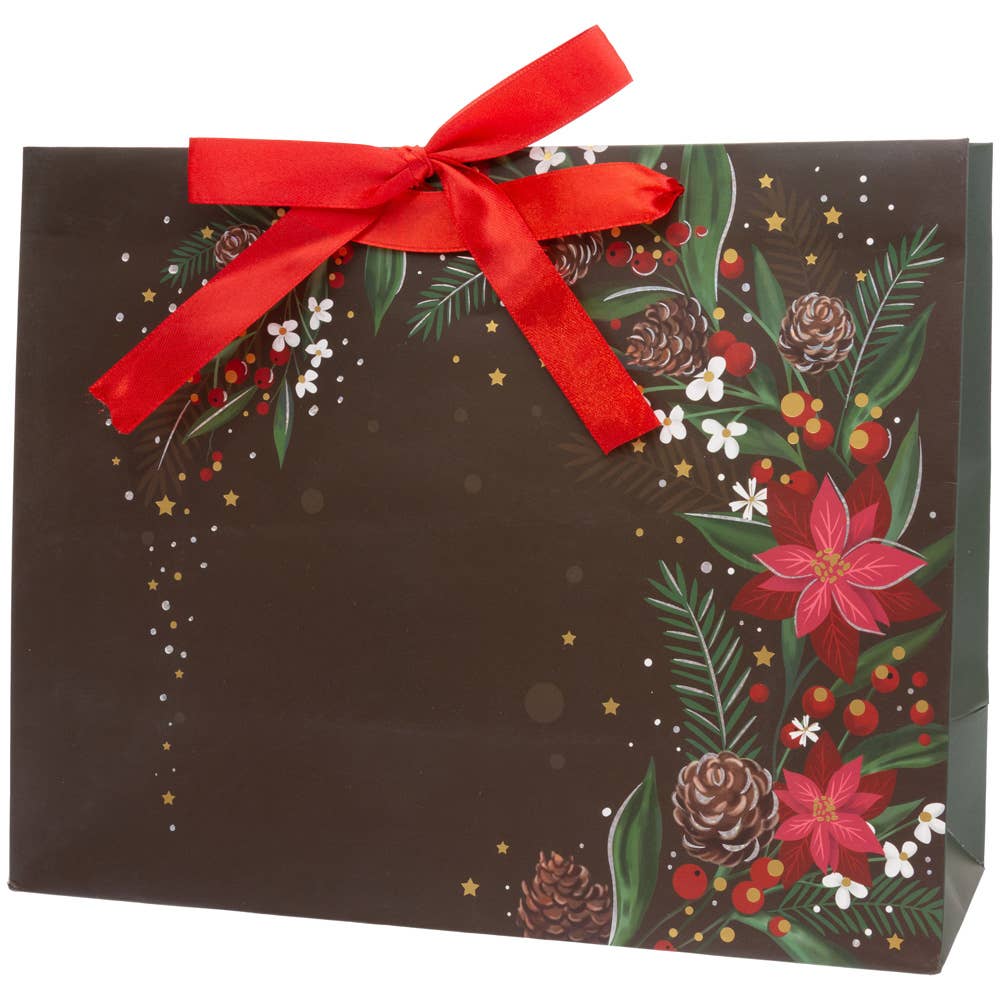 The Gift Bag: Black Christmas Floral Large is decorated with a vibrant red bow and festive botanical designs, including pinecones, red flowers, and green leaves.