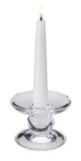 A white taper candle burns upright in the Glass Dual-Size Reversible Candle Holder, designed to fit taper, ball, and pillar candles, set against a plain background.