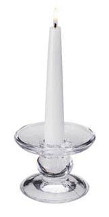 A white taper candle burns upright in the Glass Dual-Size Reversible Candle Holder, designed to fit taper, ball, and pillar candles, set against a plain background.