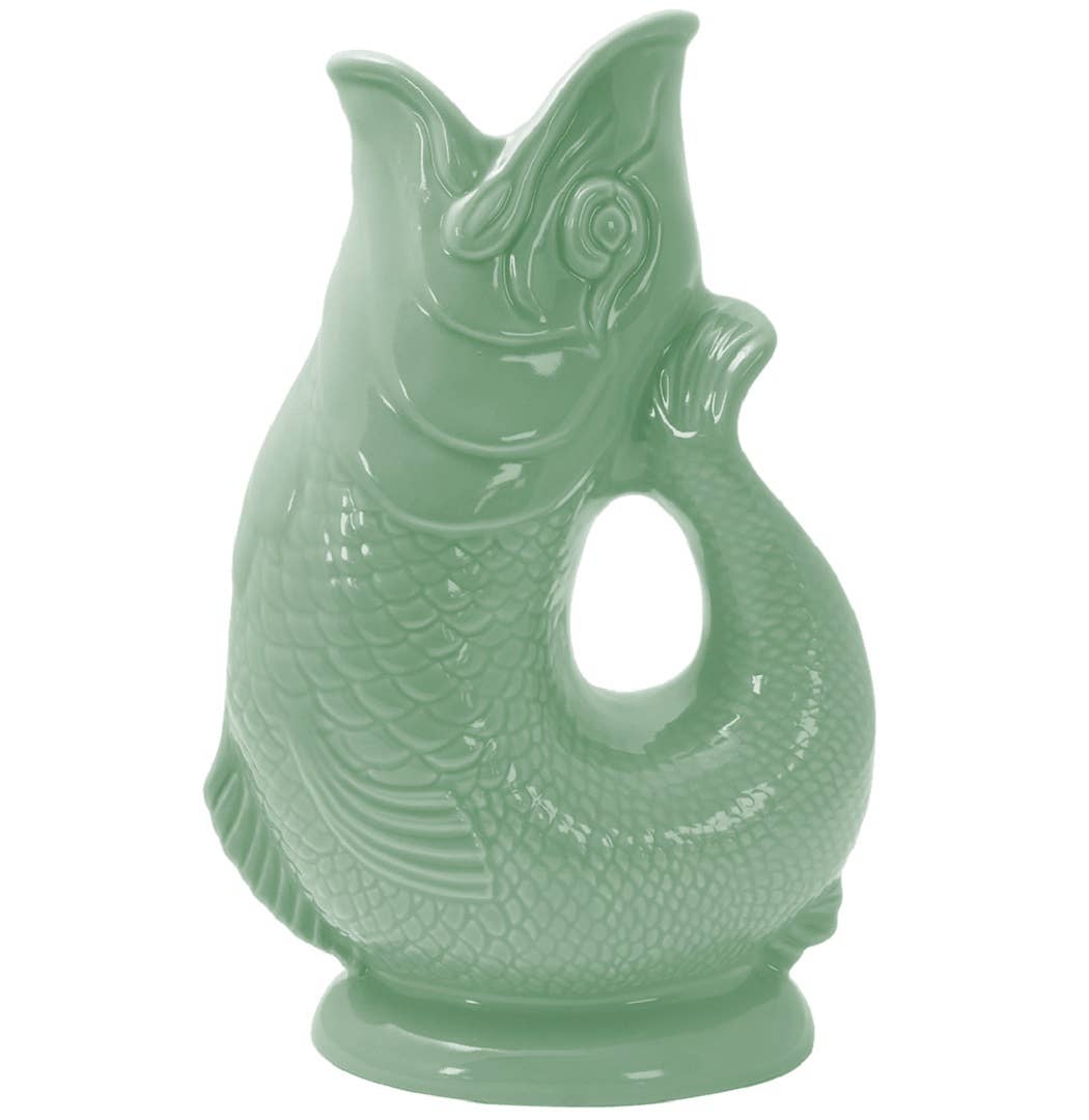 Gluggle Jug in Sage Green, a ceramic fish-shaped pitcher featuring a curling tail and open mouth, adds a delightful touch of whimsy.