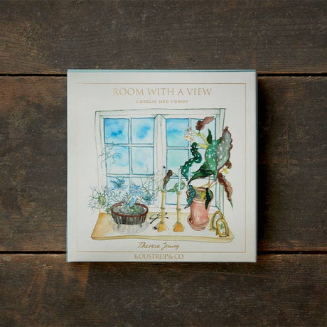 Card Pack: Room with a View - Square cardfolder featuring watercolor window and plant motifs on wooden surface, crafted on FSC paper, includes 8 cards and envelopes.