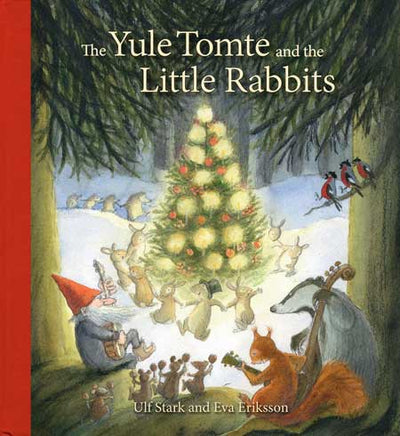 In a magical snowy forest, rabbits and woodland animals gather by a decorated tree as a Yule Tomte plays music—capturing the charm of Yule Tomte and the Little Rabbits by Ulf Stark & Eva Eriksson.