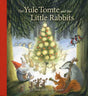 In a magical snowy forest, rabbits and woodland animals gather by a decorated tree as a Yule Tomte plays music—capturing the charm of Yule Tomte and the Little Rabbits by Ulf Stark & Eva Eriksson.