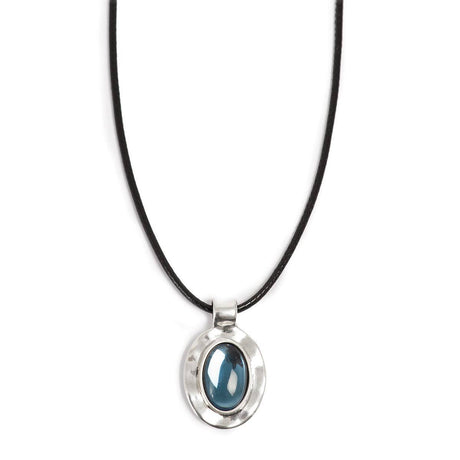 The A&C Oslo Silver Deep Blue Glass Necklace features a glossy deep blue glass stone set in a silver oval pendant on a black cord.