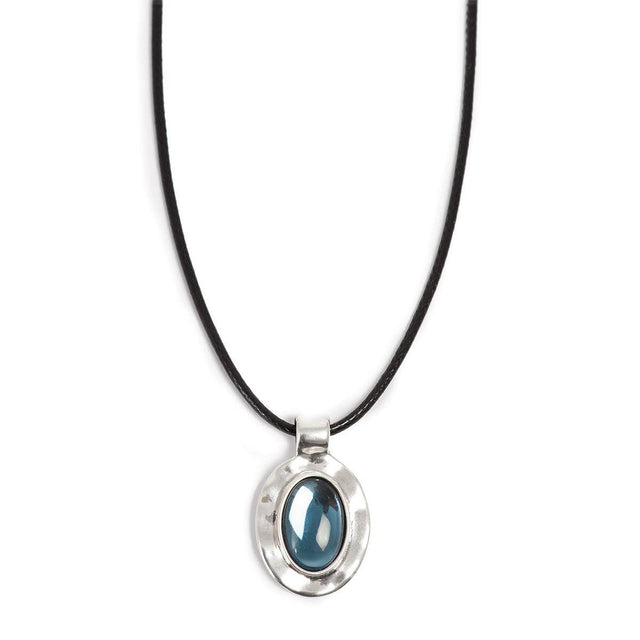 The A&C Oslo Silver Deep Blue Glass Necklace features a glossy deep blue glass stone set in a silver oval pendant on a black cord.