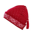 A red wool beanie by Norlender Knitwear, featuring a delightful white snowflake design and a playful tassel on top.