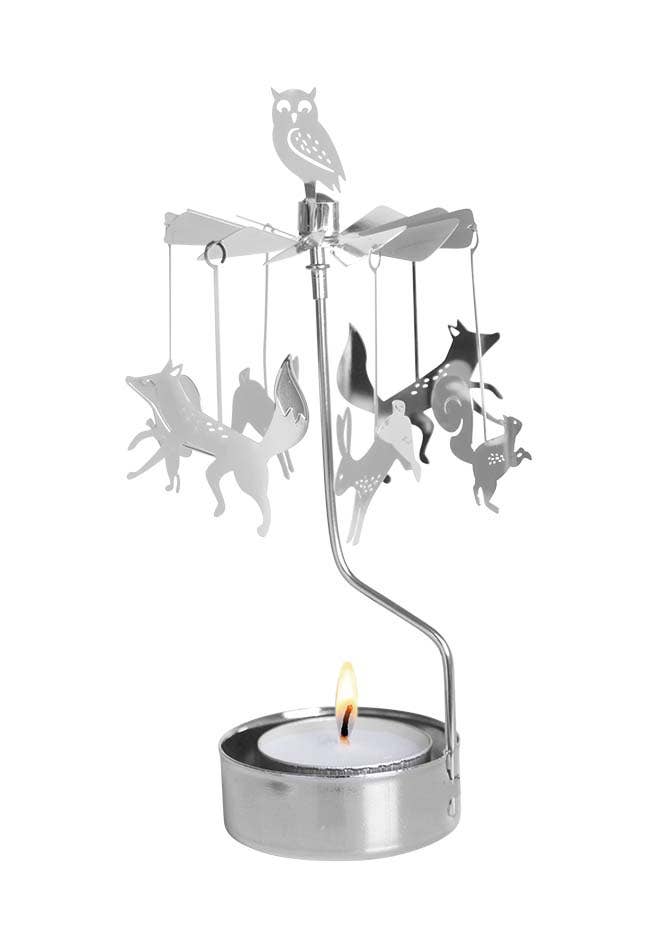 The Candle Holder: Forest Animals, Silver Rotary is made from recycled metal and showcases delightful animal silhouettes with an owl perched atop. Activated by the warmth of a burning tealight, it effortlessly brings Scandinavian design to your home decor.