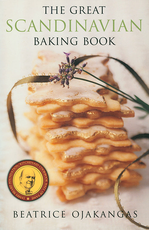 The cover of the book, "The Great Scandinavian Baking Book" by Beatrice Ojakangas, beautifully features stacked pastries adorned with a sprig of lavender, celebrating the art of Nordic recipes.