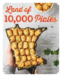 Cover of the book *Land of 10,000 Plates: Stories and Recipes from Minnesota* by Patrice M. Johnson, showcasing a tater tot hotdish arranged in a dish shaped like Minnesota. Parsley garnish and wild rice accompany it, enhancing beloved food traditions.