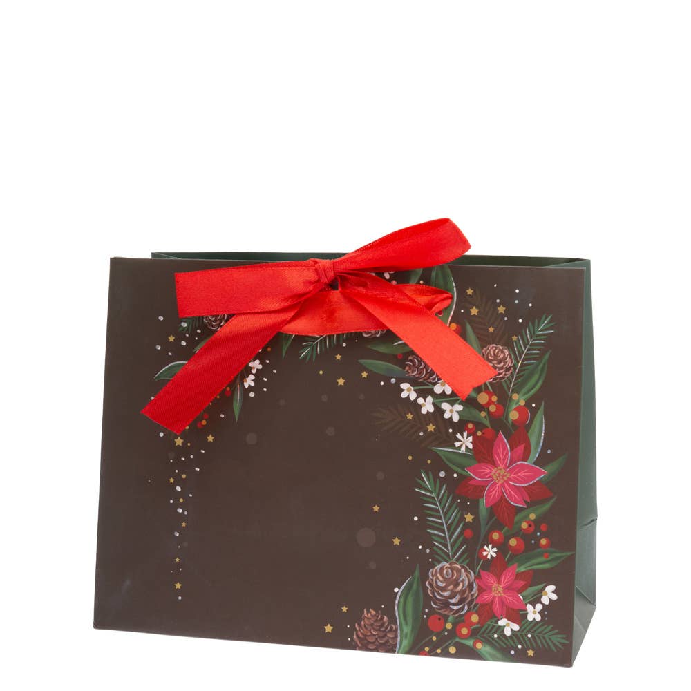 A Gift Bag: Black Christmas Floral Medium, made from paper, features a red ribbon and festive designs with Christmas floral patterns and pinecones.