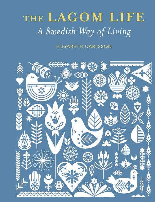 The cover of Book: Lagom Life A Swedish Way of Living by Elisabeth Carlsson, with white Scandinavian folk art on blue, embodies the balanced Swedish lifestyle.
