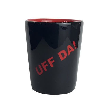The 1.5 oz Shot Glass features a sleek black exterior, bold red "Uff Da!" on the front, and a vivid red interior—a playful tribute to Scandinavian heritage.