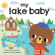 Book cover for "My Lake Baby" featuring a bear wearing a life jacket by the lake, accompanied by a cabin, boats, outdoor chairs, and campfire s'mores.